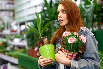 woman surprised by unusual live plant in the department of plant in market, stay in shock and look...