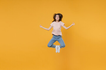 Full length portrait of smiling young woman 20s in pastel pink casual t-shirt jumping hold hands in yoga gesture, relaxing meditating, trying to calm down isolated on yellow color background studio.