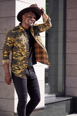 african american male model posing outdoors, walk near buildings in big city town, wearing fashionable stylish clothes. model, people concept