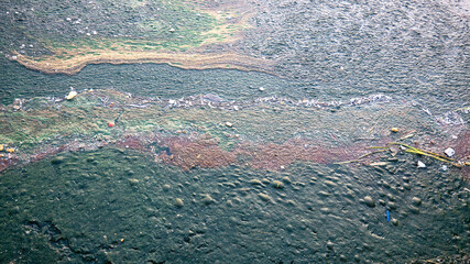 river water pollution. garbage green dirt