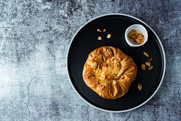Vanilla cream almonds sweet bun in a plate