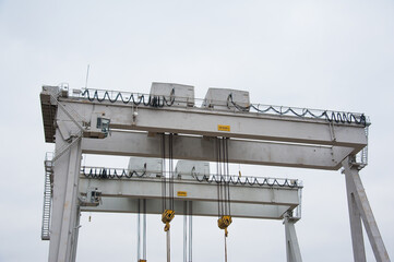 Harbor gantry crane moving a tank container