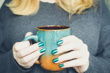 Woman holding red tea cup