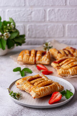 Sweet puff pastry cakes with strawberry
