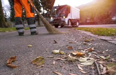 Cleaning park or street during autumn Time. Garbage collector working on a pedestrian street at the...