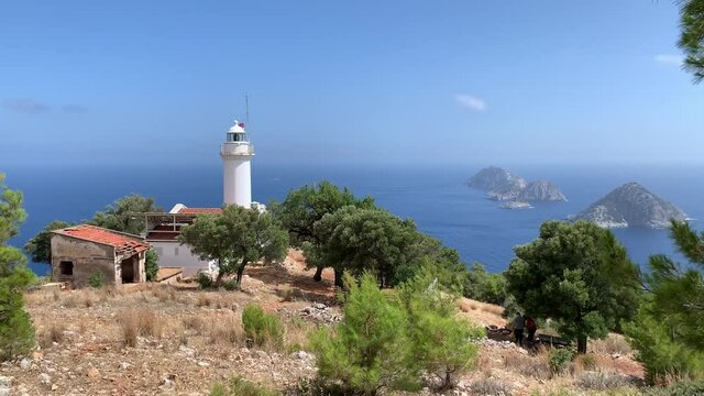 Famous Gelidonia (Gelidonya) Lighthouse in Antalya Turkey surrounded by olive and pine trees. Mediterranean sea and islands on a background. 4k stock video. 