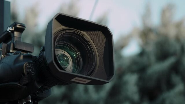 Professional broadcast camera in outdoor studio shooting video. Broadcasting industry.