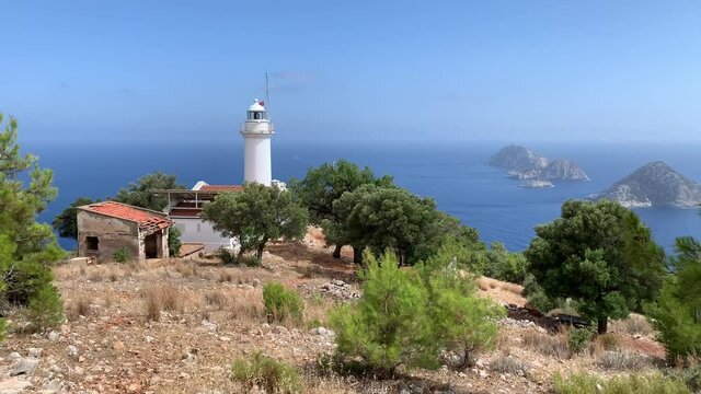 Famous Gelidonia (Gelidonya) Lighthouse in Antalya Turkey surrounded by olive and pine trees. Mediterranean sea and islands on a background. 4k stock video. 