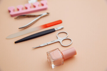 Nail care concept. A set of professional tools for manicure and pedicure on pink background.