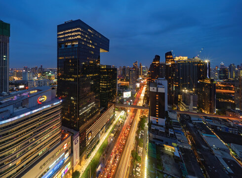 Aerial view of Rama 9 road, New CBD, Bangkok Downtown, Thailand. Financial district and business centers in smart urban city in Asia. Skyscraper and high-rise buildings at night.