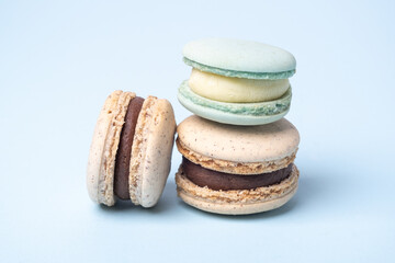 Close up of chocolate and blue cheese macaroons on blue background. Delicious french macarons