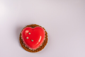round cookies with red heart close up on white wooden background