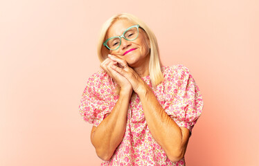 middle age woman shrugging with a dumb, crazy, confused, puzzled expression, feeling annoyed and...