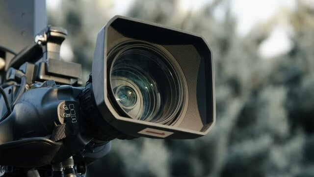 Professional broadcast camera in outdoor studio shooting video. Broadcasting industry.