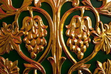 gilded bas-relief of grapes, ornate old furniture