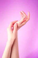 Poster Beautiful female hands showing fresh cute manicure, skin and nail care concept, purple background © Frostroomhead