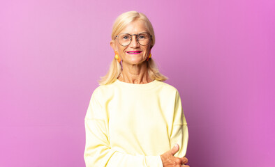 middle age woman laughing shyly and cheerfully, with a friendly and positive but insecure attitude