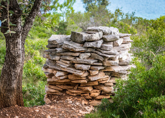 A neat pile of stones folded for the construction of the wall on the island of Lavsa, Croatia