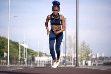 young black fitness woman running in stadium, do exercises, workout, lead healthy lifestyle. jogging