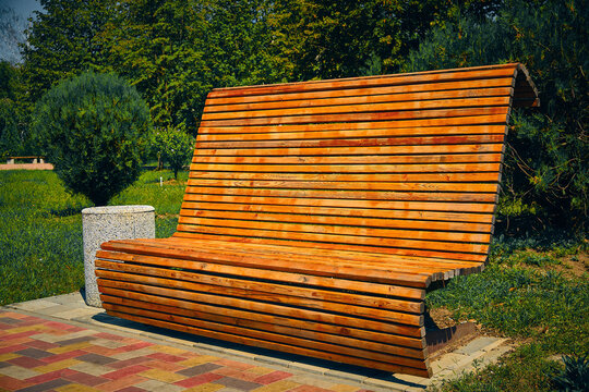 Wooden high backed bench in the park