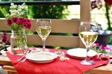 Outdoor al fresco patio table with beautiful place settings for relaxing dining on a warm summer evening 