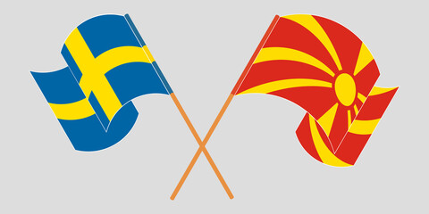 Crossed and waving flags of North Macedonia and Sweden