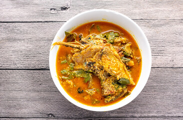 Oha soup with beef in a white ceramic plate and wooden background. Flatlay.