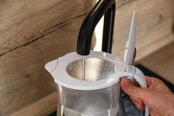 Water filter jug in kitchen sink, filling up.