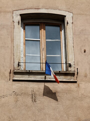 old window in the building with french flag