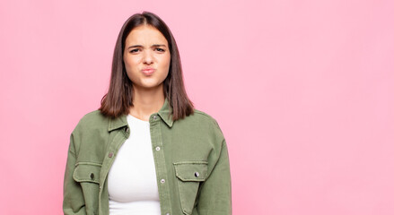 young pretty woman looking goofy and funny with a silly cross-eyed expression, joking and fooling...