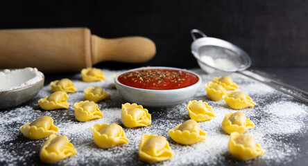 Homemade fresh tortellini on a kitchen table.