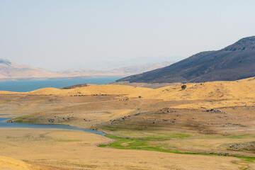 The San Luis Reservoir during dry and hot season, artificial lake on San Luis Creek in the eastern slopes of the Diablo Range of Merced County, California. USA