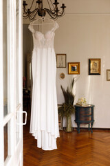 wedding dress on a hanger in the apartment