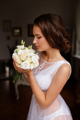 Bride in the morning with a bouquet of flowers makeup