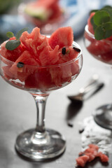 Summer fruit, snack. Fresh watermelon slices in glass cup. Healthy, juicy fruit.