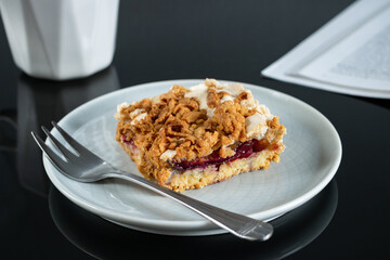 Cake on a plate, coffee and a magazine fragment