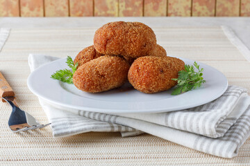 portion of stuffed fried croquettes on a plate