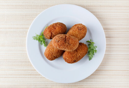 portion of stuffed fried croquettes on a plate