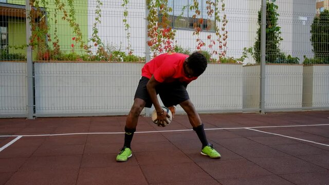 Black guy soccer player shows feints with the ball. A man on a soccer field