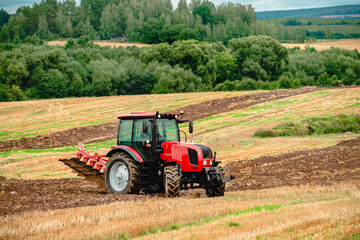 Fototapeta na wymiar farmer on a tractor plowing the land