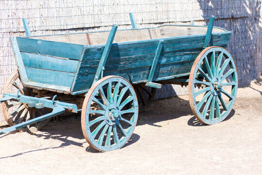 Old rustic cart painted with blue paint in modern interior