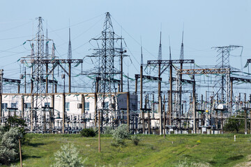 Power station, high voltage wires are against the sky. Power lines. High voltage power pylons