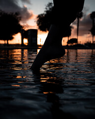 foot in water at sunset