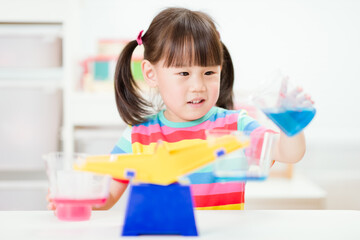 young girl play balance toy for homeschooling