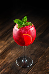 Red sangria in a wine glass with mint and ice