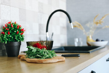 Fresh organic arugula leaves on cutting board. Arugula or rucola for salad on wooden table.
