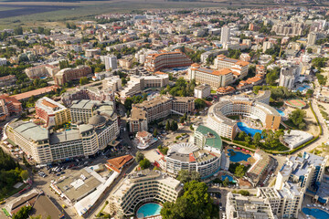 Suny Beach, Bulgaria - August 09, 2019: Aerial image a drone resort in Bulgaria on Black Sea coast. Many hotels and beaches with tourists, sunbeds and umbrellas. Sea travel destination. Travel