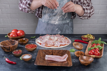 Pizza preparation with chef hands. Cutting pizza