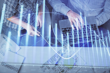 Multi exposure of man and woman working together and forex graph hologram drawing. Financial analysis concept. Computer background. Top View.