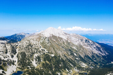 Aerial view from the drone. A stunning view of the mountain peaks in Bulgaria, shot from a drone in the morning at dawn. Travel and vacation concept.